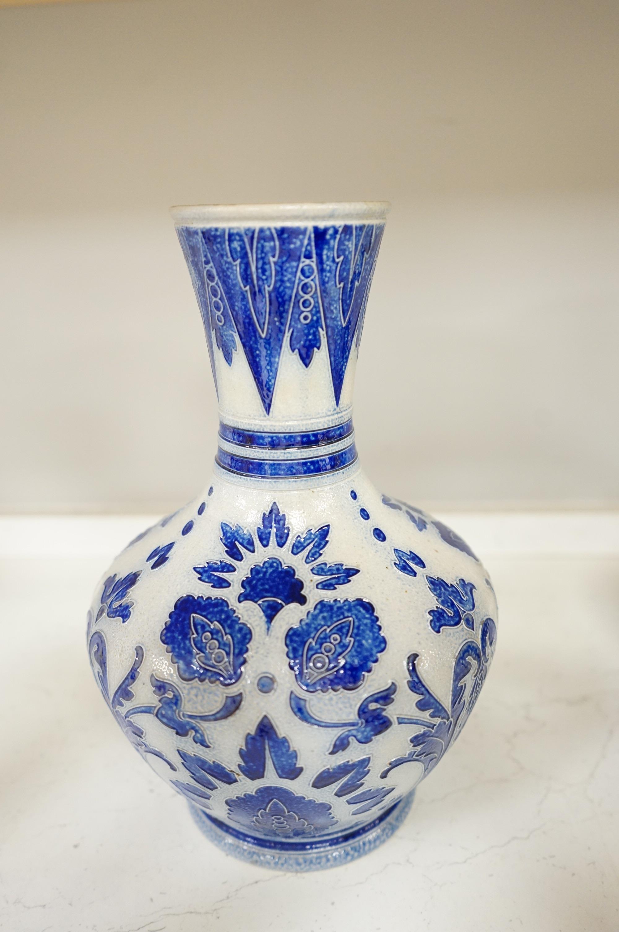 A collection of late 19th century and early 20th century European pottery and stoneware items to include a pair of glazed candlesticks stamped Belgium, largest 36cm high